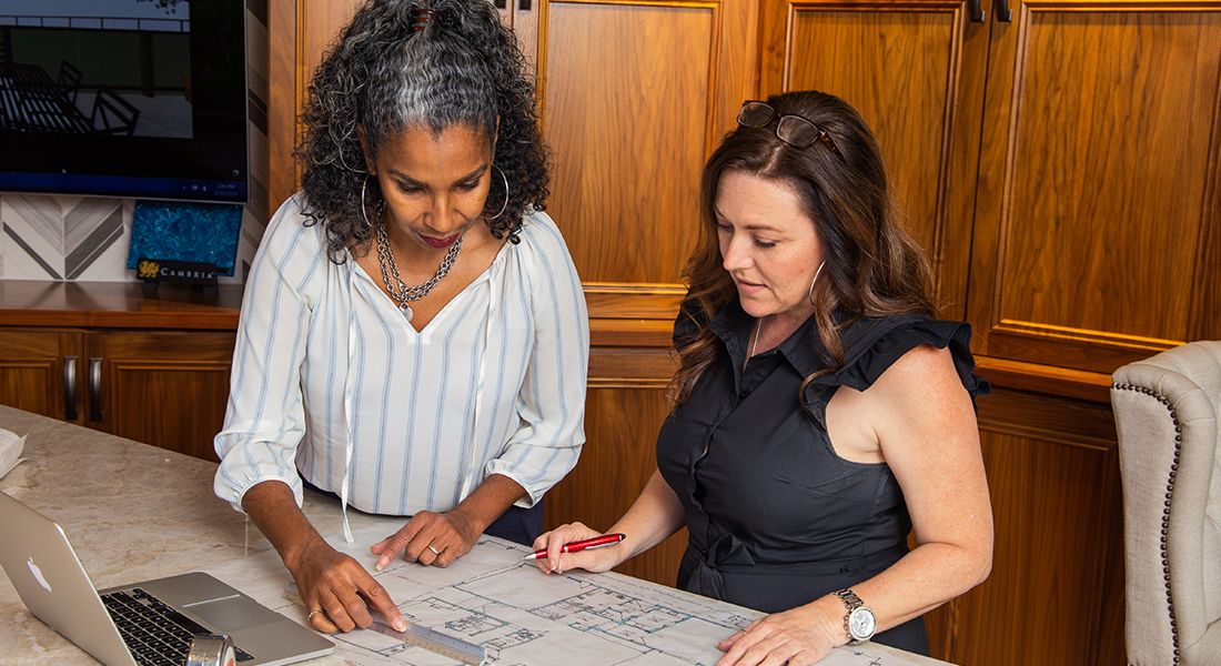 Two female designers going over plans